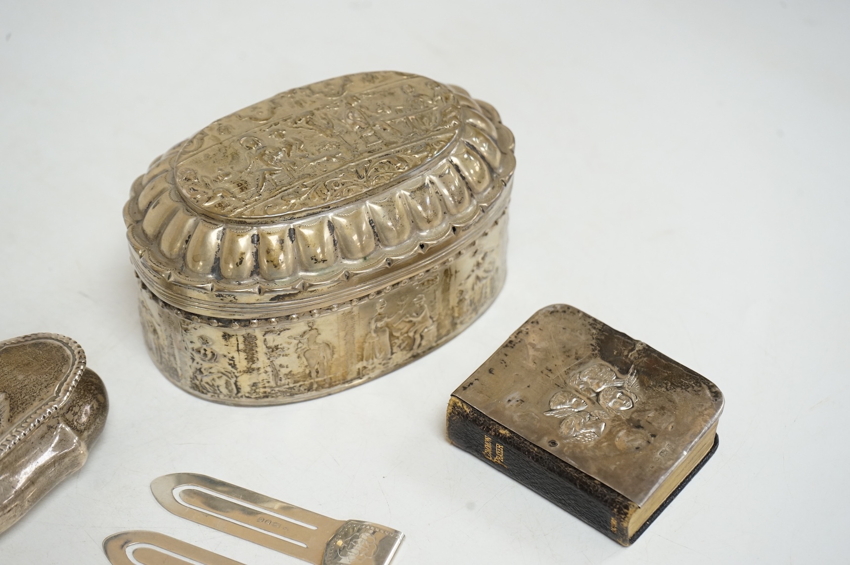Three late 19th/early 20th century repousse silver trinket boxes, including one with Reynold's Angels decoration, Birmingham, 1899, 91mm, a larger 19th century Dutch white metal oval box and cover, a pair of wishbone sil